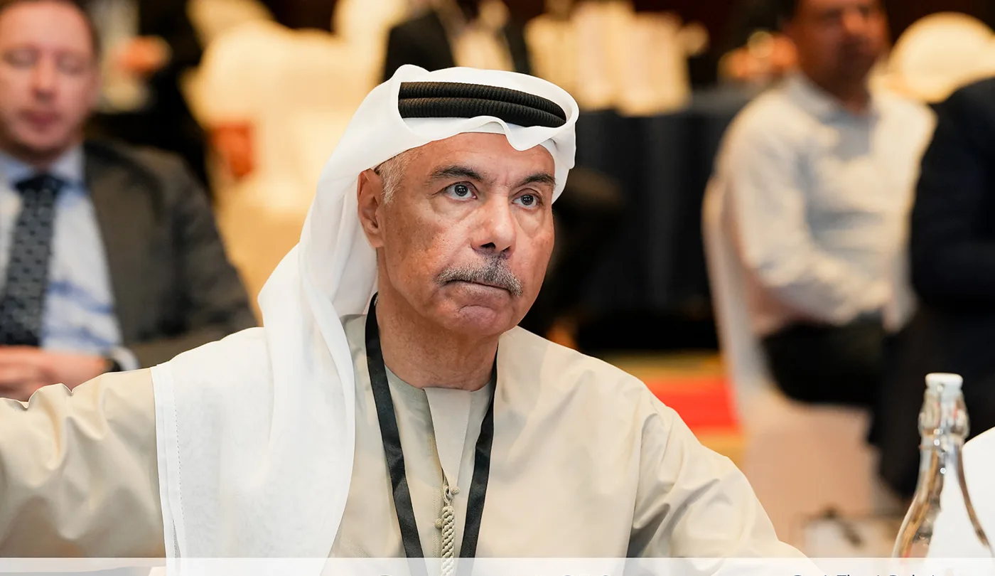 Senior finance leader listening during a summit session